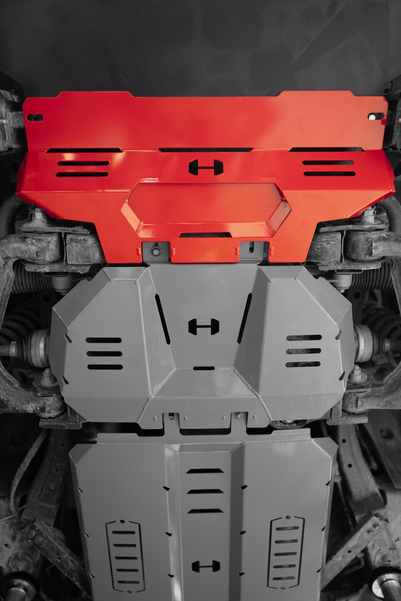 Red powder-coated Hamer bash plate for Kia Tasman (2025 – Present) underbody protection.